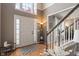 Welcoming foyer with hardwood floors, staircase, and natural light from a transom window at 828 Breaside Ln, Greenwood, IN 46143