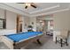 Spacious game room features a stylish billiard table and access to other rooms in the home at 828 Breaside Ln, Greenwood, IN 46143