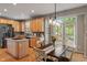 Cozy kitchen featuring stainless steel appliances, wood cabinets, an island, and an adjacent dining area at 828 Breaside Ln, Greenwood, IN 46143
