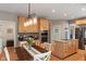 Bright kitchen with wood cabinets, stainless steel appliances, granite counters, island, and dining space at 828 Breaside Ln, Greenwood, IN 46143