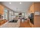 Inviting kitchen offering granite counters, wood cabinets, island cooktop, and an open layout at 828 Breaside Ln, Greenwood, IN 46143