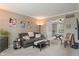 Comfortable living room with neutral colors, plush seating, and a view into the game room at 828 Breaside Ln, Greenwood, IN 46143