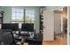 Bright home office featuring a large window, desk, and built-in shelving for optimal organization at 828 Breaside Ln, Greenwood, IN 46143