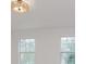 This bedroom boasts a contemporary light fixture and two windows that provide natural light at 8300 Weaver Woods Pl, Fishers, IN 46038
