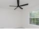 The carpeted bedroom features a modern ceiling fan and a bright window at 8300 Weaver Woods Pl, Fishers, IN 46038