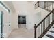 Inviting foyer with wood-look floors, white trim, and a staircase with dark wood banisters at 8300 Weaver Woods Pl, Fishers, IN 46038