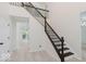 Bright foyer with a staircase featuring dark wood banisters and white risers at 8300 Weaver Woods Pl, Fishers, IN 46038