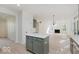 Bright, open kitchen with light-colored cabinets, an island, and modern appliances at 8300 Weaver Woods Pl, Fishers, IN 46038