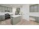 Modern kitchen featuring stainless steel appliances, an island and sage-colored cabinets at 8300 Weaver Woods Pl, Fishers, IN 46038