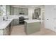 Modern kitchen features sage cabinets, stainless appliances, and a functional island layout at 8300 Weaver Woods Pl, Fishers, IN 46038