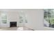 Bright living room featuring a black fireplace and large windows with a wooded view at 8300 Weaver Woods Pl, Fishers, IN 46038