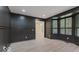 Stylish room featuring dark paneled walls, wood-look floors, and a bright window at 8300 Weaver Woods Pl, Fishers, IN 46038