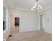 Spacious room with wood-look floors, bright white trim, and an elegant light fixture at 8300 Weaver Woods Pl, Fishers, IN 46038