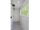 This shower features sleek black fixtures and an oversized window for abundant natural light at 8300 Weaver Woods Pl, Fishers, IN 46038