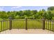 View of the expansive, lush green backyard from a wooden deck with a brown railing at 888 Westcreek Dr, Columbus, IN 47201