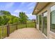 Back deck area overlooking a verdant backyard; trees and blue skies fill the horizon at 888 Westcreek Dr, Columbus, IN 47201