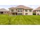 A spacious backyard with a well-manicured lawn and patio at 888 Westcreek Dr, Columbus, IN 47201