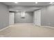 Finished basement with neutral walls and carpet, white baseboards and trim, and a closet and access to other rooms at 888 Westcreek Dr, Columbus, IN 47201