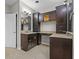 Bright bathroom with dual sinks, granite counters, wood cabinetry, and a large mirror at 888 Westcreek Dr, Columbus, IN 47201