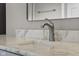 Close-up of a modern bathroom sink featuring brushed nickel fixtures and a white marble countertop at 888 Westcreek Dr, Columbus, IN 47201