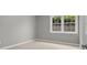 A compact carpeted bedroom with a bright window at 888 Westcreek Dr, Columbus, IN 47201