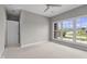 Spacious bedroom showcasing a ceiling fan and a large window view of the neighborhood at 888 Westcreek Dr, Columbus, IN 47201