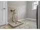 A dog washing station featuring a tiled shower, a handheld shower head, and tile flooring, with a window nearby at 888 Westcreek Dr, Columbus, IN 47201