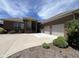 Charming brick home featuring an attached two car garage and an expansive driveway at 888 Westcreek Dr, Columbus, IN 47201