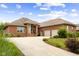Inviting brick home featuring an attached two car garage and winding concrete driveway under a partly cloudy sky at 888 Westcreek Dr, Columbus, IN 47201