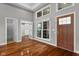 Inviting foyer featuring hardwood floors, a front door, and a staircase leading to the upper level at 888 Westcreek Dr, Columbus, IN 47201
