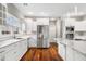 Bright and airy kitchen featuring stainless steel appliances, white cabinets, hardwood floors, and granite countertops at 888 Westcreek Dr, Columbus, IN 47201