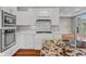 Modern kitchen featuring white cabinets, granite countertops, stainless steel appliances, and hardwood floors at 888 Westcreek Dr, Columbus, IN 47201