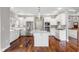 Modern kitchen featuring an island, hardwood floors, stainless steel appliances, and white cabinets at 888 Westcreek Dr, Columbus, IN 47201