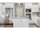 Close up view of the modern kitchen island featuring stainless steel appliances, white cabinets and hardwood floors at 888 Westcreek Dr, Columbus, IN 47201