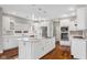 Well lit kitchen featuring hardwood floors, a large island, stainless steel appliances, and ample counter space at 888 Westcreek Dr, Columbus, IN 47201