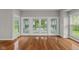 Bright living room featuring hardwood floors, multiple windows, and glass doors leading to the backyard at 888 Westcreek Dr, Columbus, IN 47201