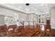 Spacious living room with hardwood floors, a modern chandelier, and natural light streaming through large windows at 888 Westcreek Dr, Columbus, IN 47201