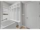 Mud room featuring built-in cubbies and benches and a utility sink, with a door leading to other rooms and a window at 888 Westcreek Dr, Columbus, IN 47201