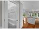 Elegant pantry with a decorative door, hardwood floors, and a view of the kitchen and backyard at 888 Westcreek Dr, Columbus, IN 47201