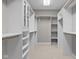 Spacious walk-in closet with custom shelving, wooden racks, and plenty of storage for clothes and shoes at 888 Westcreek Dr, Columbus, IN 47201