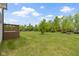 Large backyard featuring a spacious lawn, mature trees, and playset at 932 Silverheels Dr, Westfield, IN 46074