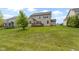 Exterior view of home showcasing a large backyard with an expansive lawn and patio at 932 Silverheels Dr, Westfield, IN 46074