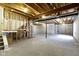 Unfinished basement with exposed beams and concrete floor, offering potential for customization at 932 Silverheels Dr, Westfield, IN 46074
