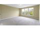 A carpeted bedroom with natural light shining through three large windows at 932 Silverheels Dr, Westfield, IN 46074