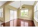Bright dining room with wood floors, large windows, and sliding glass door to outside at 932 Silverheels Dr, Westfield, IN 46074