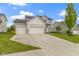 Beautiful home featuring a three-car garage and a well-manicured front lawn at 932 Silverheels Dr, Westfield, IN 46074