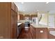 Updated kitchen features stainless steel appliances, center island, and wood cabinetry for ample storage at 932 Silverheels Dr, Westfield, IN 46074