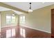 Bright living room boasts high ceilings, large windows, and ceiling fans for natural light and ventilation at 932 Silverheels Dr, Westfield, IN 46074