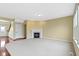Bright living room features a cozy fireplace, plush carpet, and ample natural light from large windows at 932 Silverheels Dr, Westfield, IN 46074