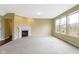 Inviting living room with a fireplace, large windows, and a neutral color scheme offers a relaxing space at 932 Silverheels Dr, Westfield, IN 46074